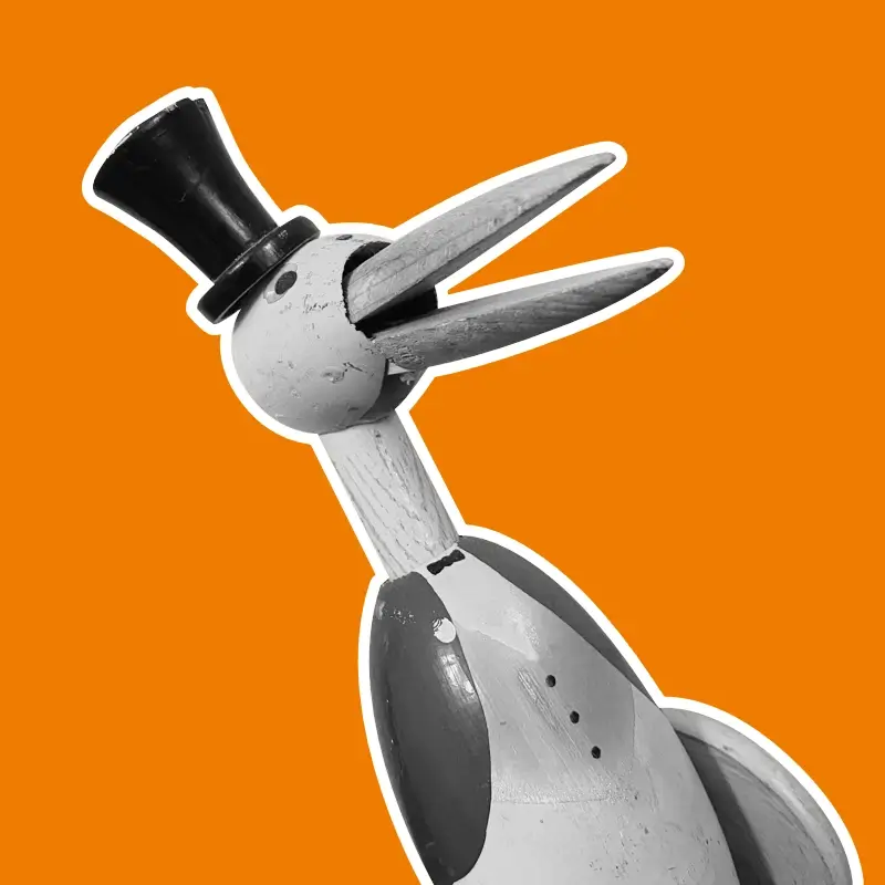 Jouet ancien, cigogne mécanique en bois, noir et blanc sur fond orange
