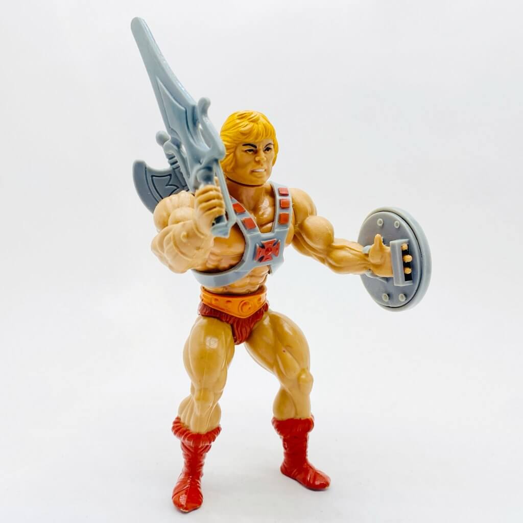 MOTU, Les Maîtres de l'Univers, Musclor, He-Man. Vue de profil, en pieds avec son glaive.